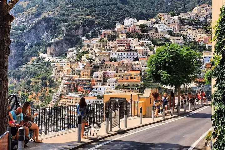 Colorful hillside houses in Positano seen from a scenic road, part of the Positano, Amalfi, and Ravello tour from Naples.