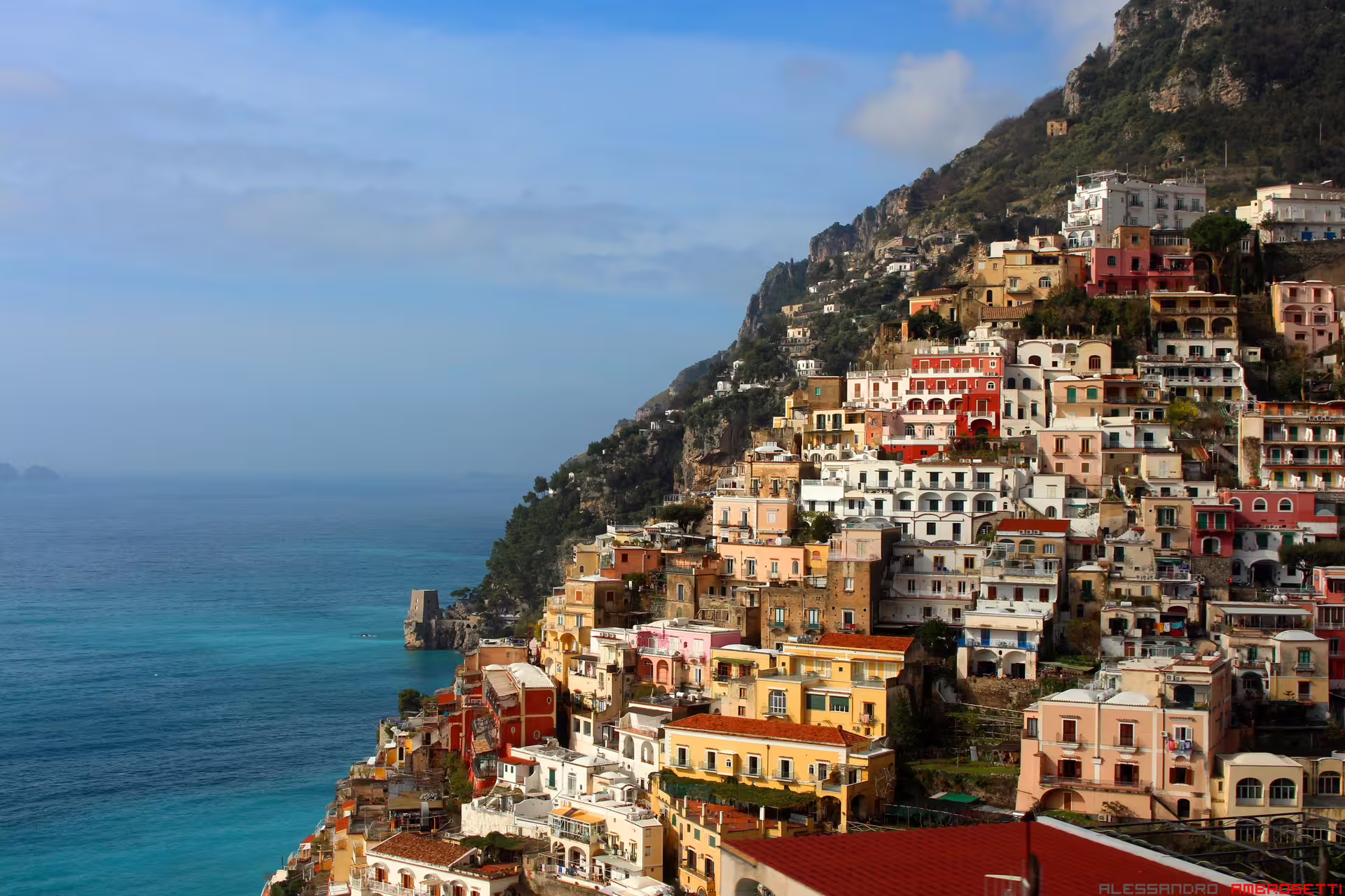 Colorful cliffside houses of Positano overlooking turquoise sea on a Mediterranean Passion 9 days self drive tour Italy