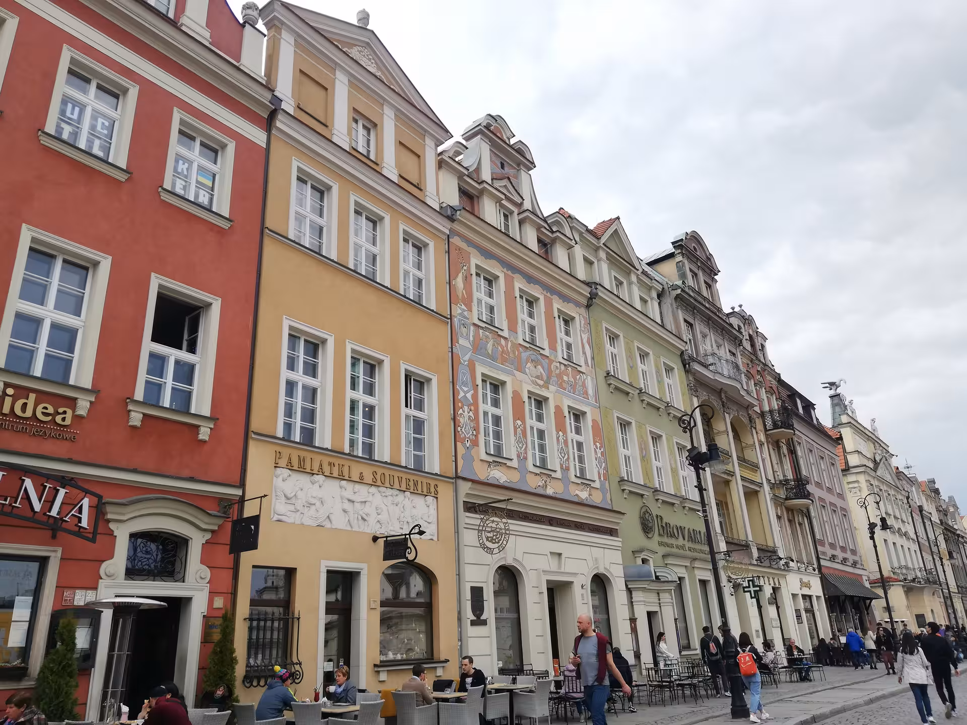 Colorful historic tenement houses lining Poznan Old Market Square during a self-guided city exploration game tour