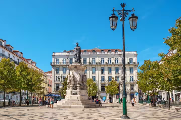 Praça Luís de Camões in Lisbon's vibrant Chiado district, showcasing historic architecture and lively atmosphere.