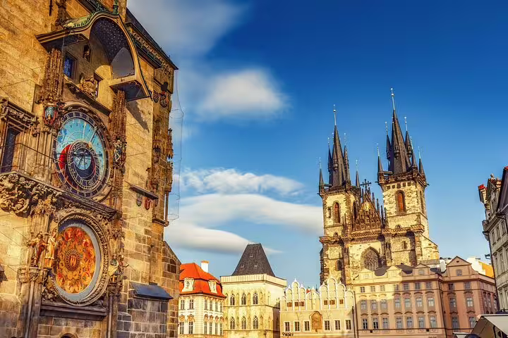 Prague Old Town Square with ornate Astronomical Clock tower and Gothic Church of Our Lady before Týn