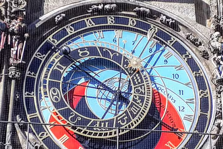 Prague Astronomical Clock face with blue zodiac dials and Roman numerals on Old Town Hall tower