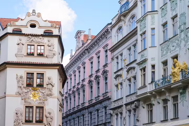 Ornate Baroque and Art Nouveau building facades in Prague Old Town with gilded sculptures