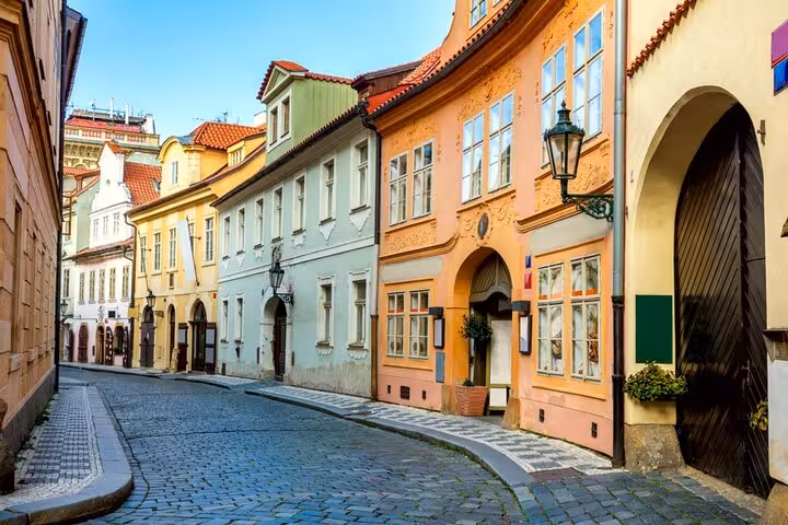 Colorful historic buildings lining a cobblestone street in Prague's old town