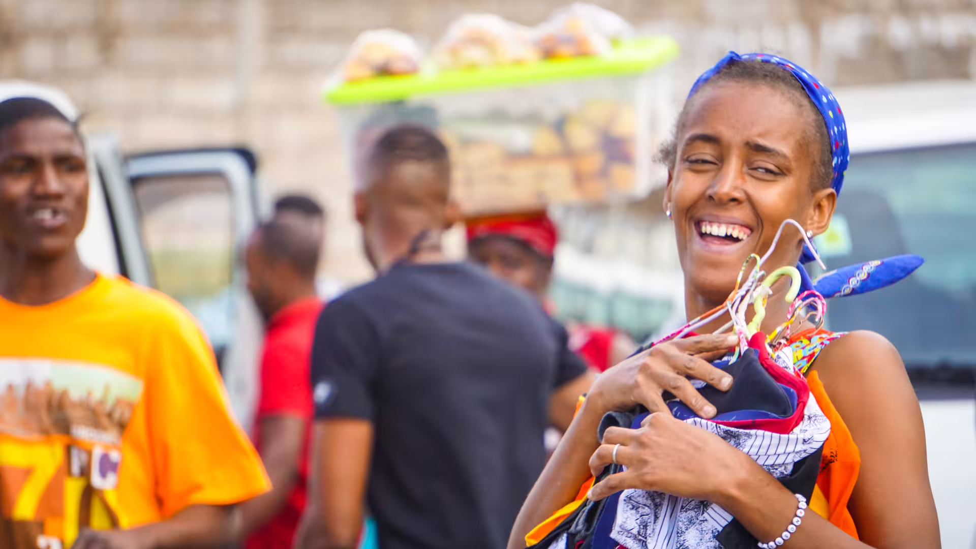 Local vendors smiling and interacting at Praia market during guided historic walking tour with locals.