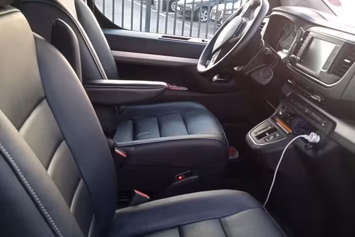 Luxury black leather interior of premium car with spacious front seats and touchscreen dashboard