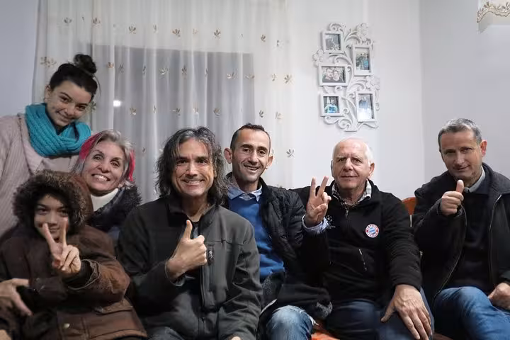 Group of tourists enjoying a cozy gathering during a premium walking tour in Berat with expert guides.
