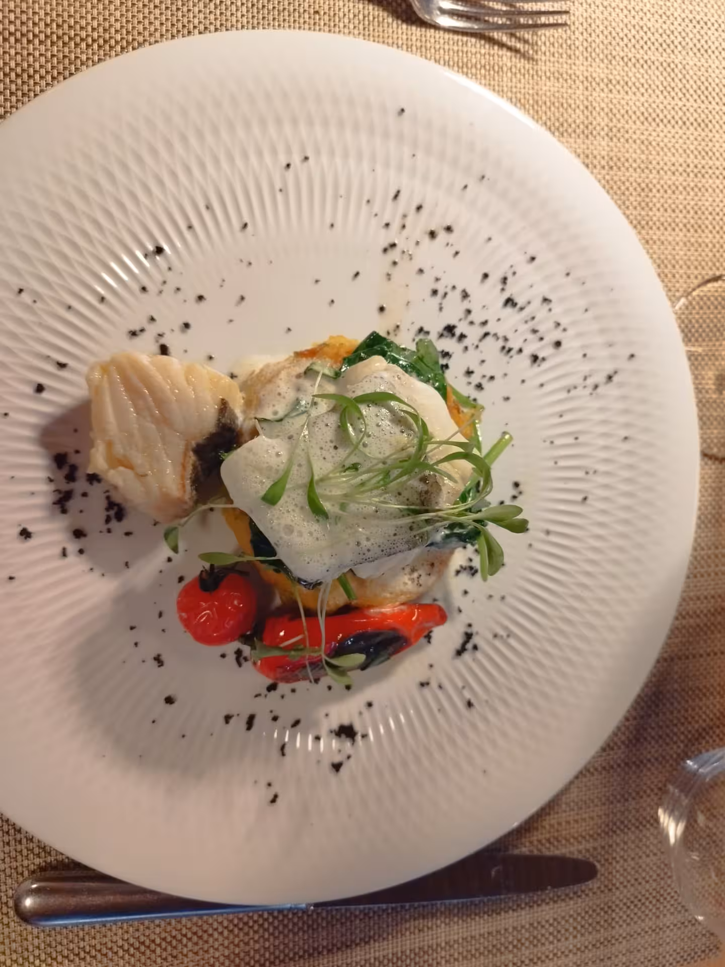 Prestige Tour gourmet dinner plate with elegant fish course, microgreens and roasted peppers at fine dining