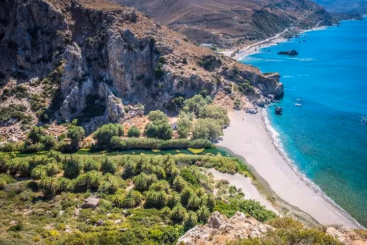 Aerial view of Preveli Palm Beach and palm forest lagoon in south Crete, day tour from Rethymno