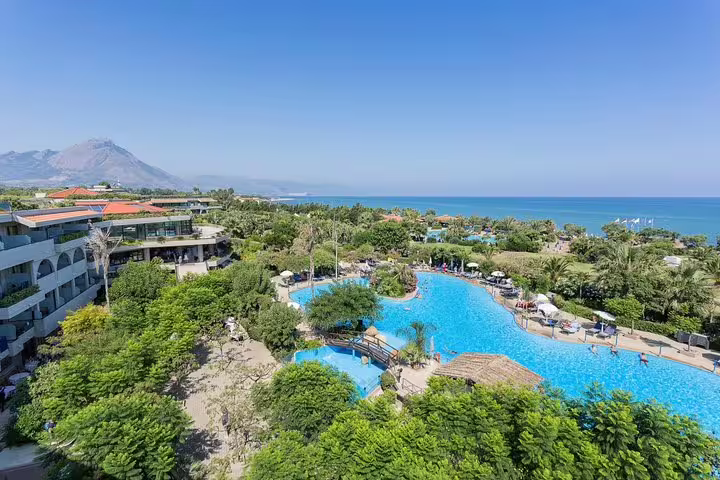 Business traveler stepping from chauffeured sedan, showcasing private airport transfer service Palermo–Campofelice di Roccella
