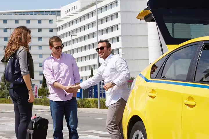 Travelers meet driver by taxi for private half-day Athens sightseeing tour with hotel pickup and drop-off