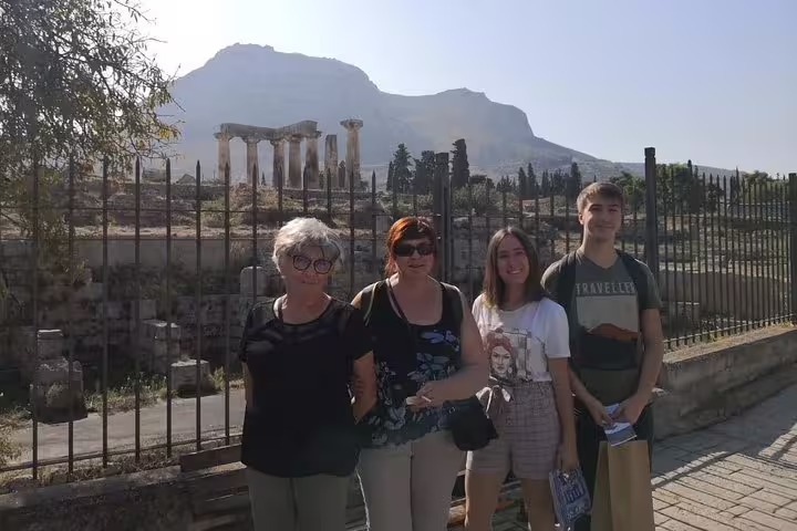 Private full-day Athens tour group photo near Ancient Agora ruins with Acropolis hill in the background
