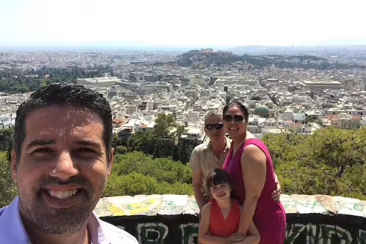 Private full-day Athens tour group photo with panoramic city views from a scenic hill viewpoint