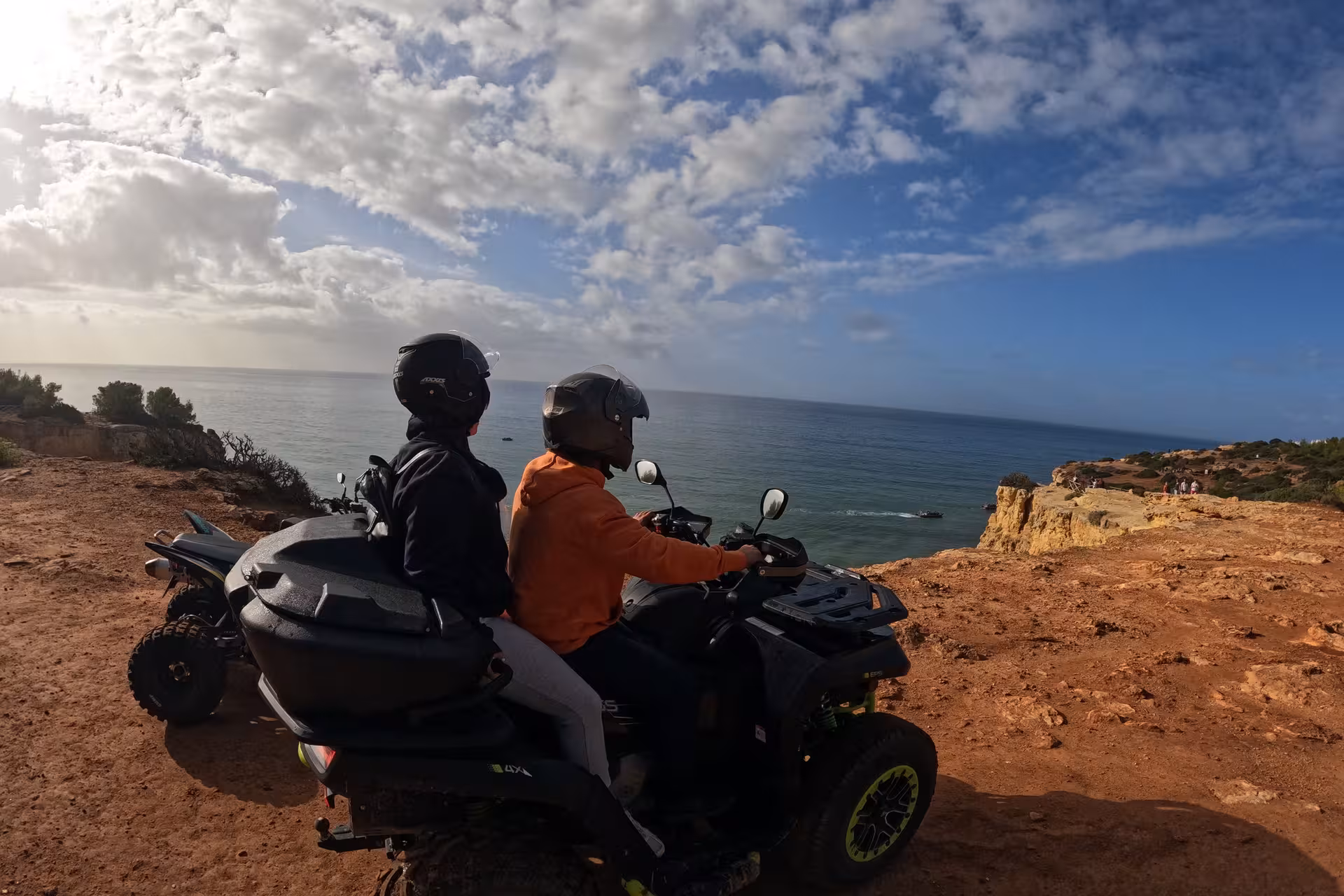Two riders on an ATV admire the stunning coastal views during the private tour of the seven Hanging Valleys.
