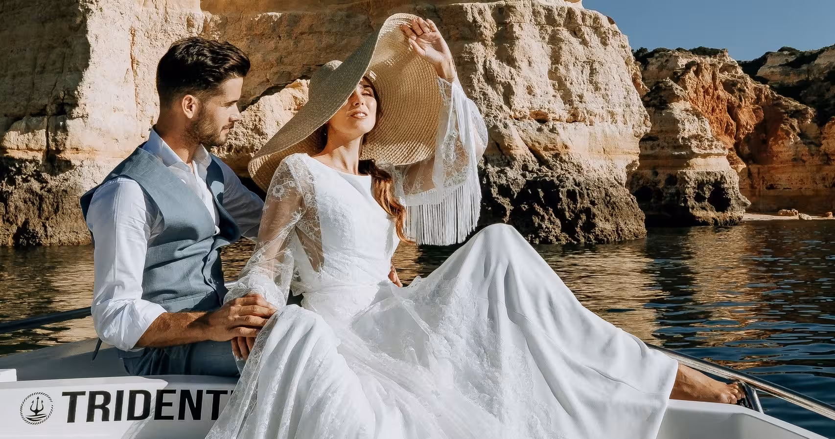 Elegant couple enjoying a private Benagil Cave deluxe boat tour along the stunning Algarve coastline cliffs.