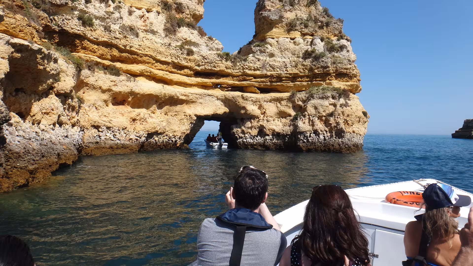 Guests on private boat cruise to Ponta da Piedade sea caves in Lagos Algarve, heading to a swim spot