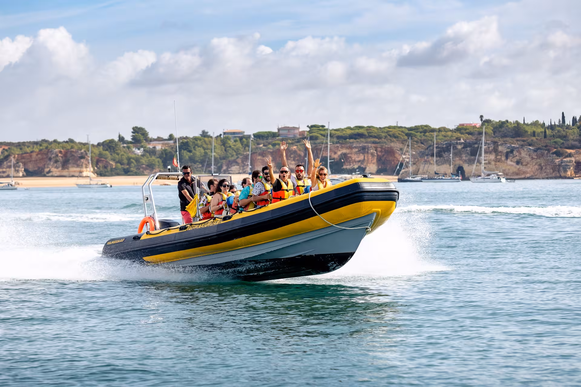 Thrilled passengers enjoy a high-speed ride on a private boat rental with scenic coastal views.