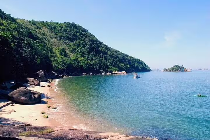 Scenic view of a secluded beach and lush hills, a highlight of the private boat tour in Santos.