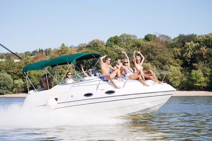 Group of friends having fun on a private boat tour in Santos, enjoying sunny weather and scenic views.
