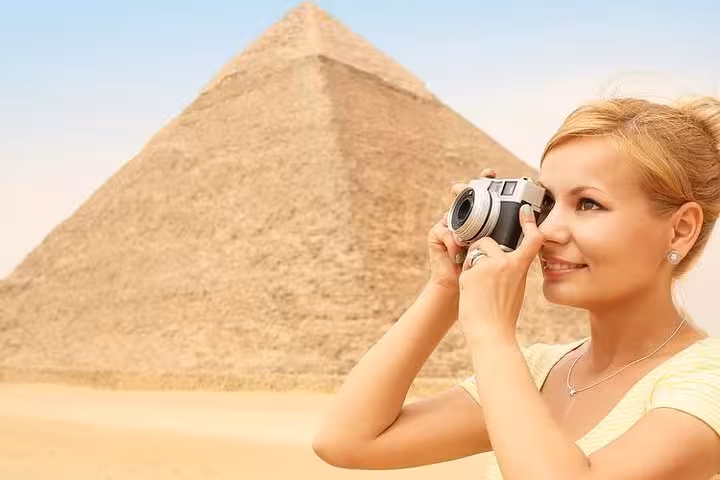 Tourist photographing the Great Pyramid of Giza on a private Cairo day tour from Hurghada, El Gouna and Soma Bay