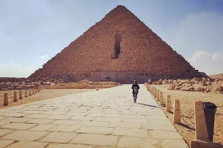 Traveler walking to the Great Pyramid of Giza on a private Cairo day trip from Hurghada with guide