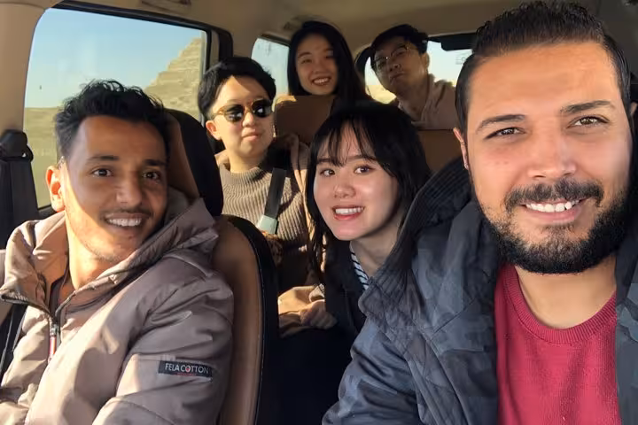 Guests and guide in tour van near Giza Pyramids, private 3-day Cairo Giza Alexandria city and food tour
