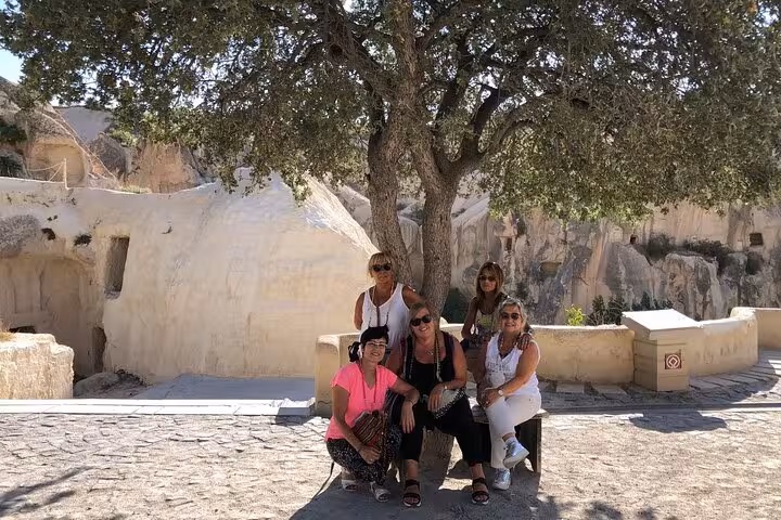 Travelers rest by cave dwellings in Cappadocia on a private tour with English guide and luxury vehicle