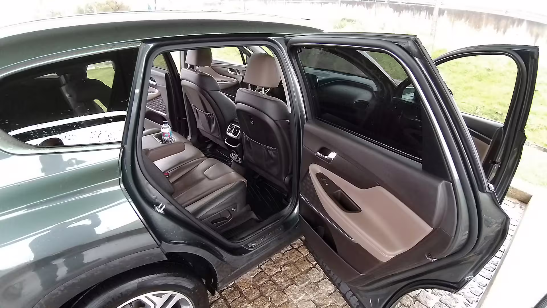 Spacious and comfortable interior of a private transfer car from Porto to Tomar, highlighting luxury travel amenities.