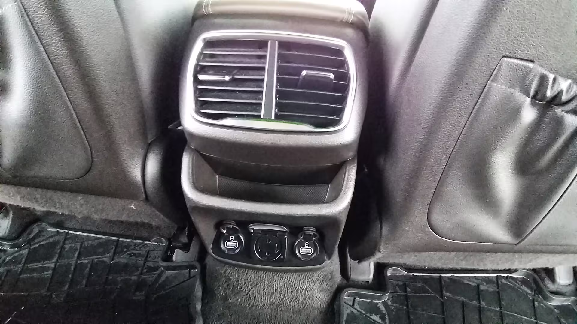 Close-up of rear air vents and USB ports in a private transfer car, ensuring comfort on Porto to Vila do Conde trips.