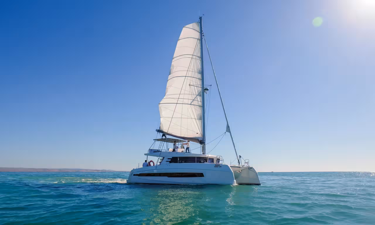 Elegant private catamaran sailing on calm turquoise waters during a full-day boat tour in Vilamoura Algarve