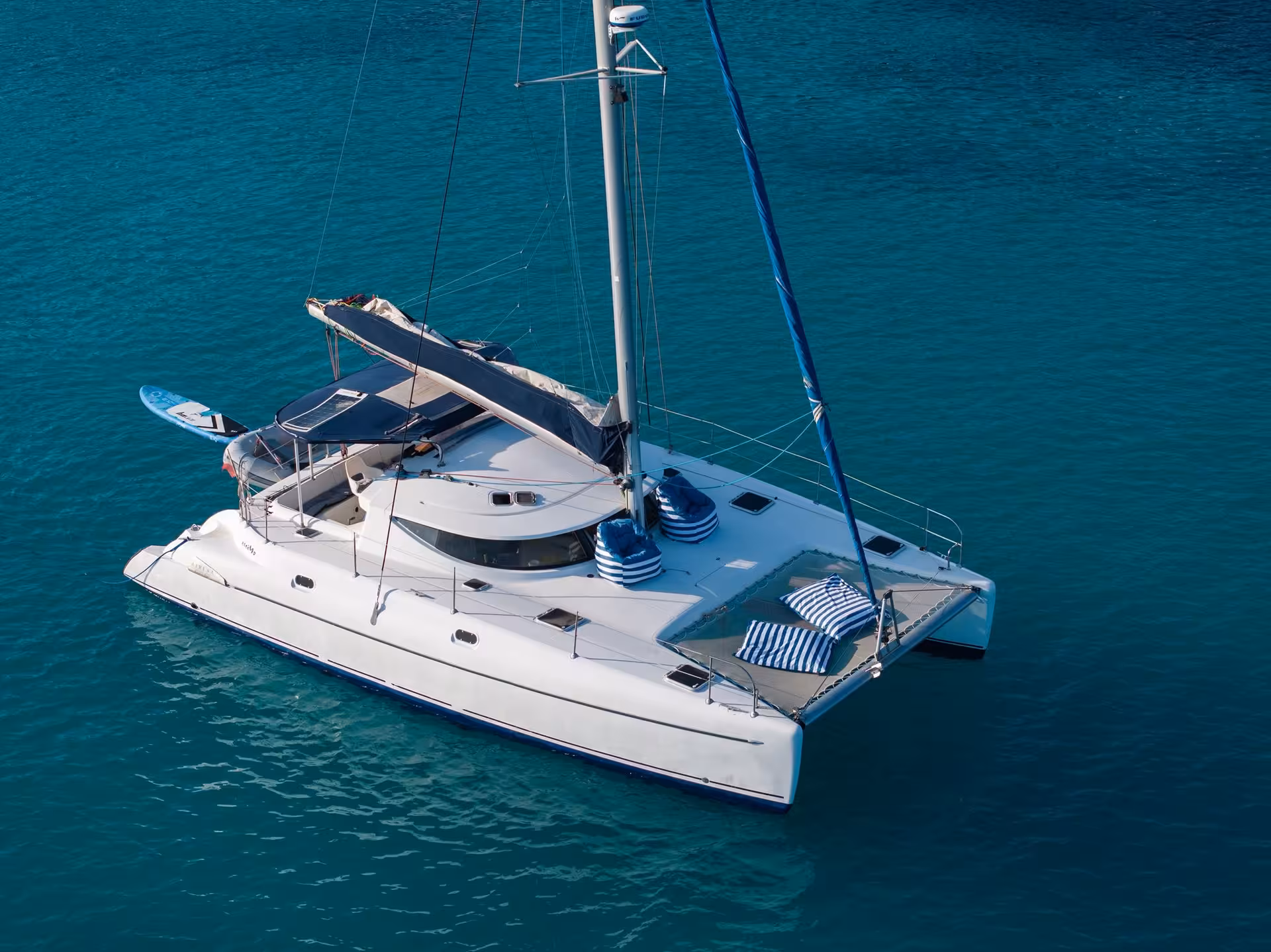 Aerial view of a white luxury catamaran sailing on turquoise waters near Cannes