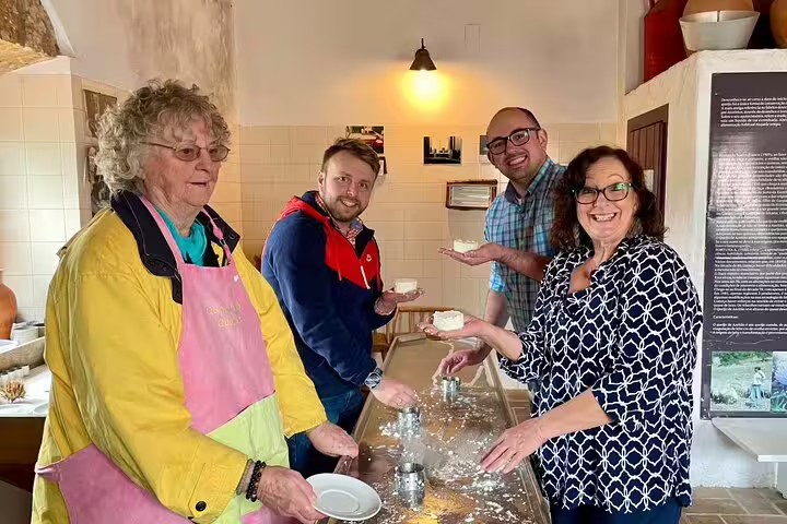 Participants enjoying hands-on cheese making during a private Azeitão workshop, paired with wine tasting and Sesimbra tour.