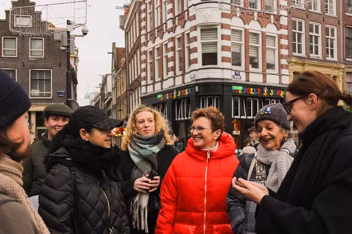 Small group chatting on a lively street during a private city walking experience with a local guide