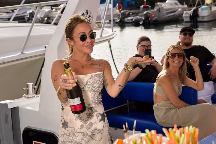 Guests enjoying a celebratory moment with champagne on a private cruise, highlighting luxury and relaxation.