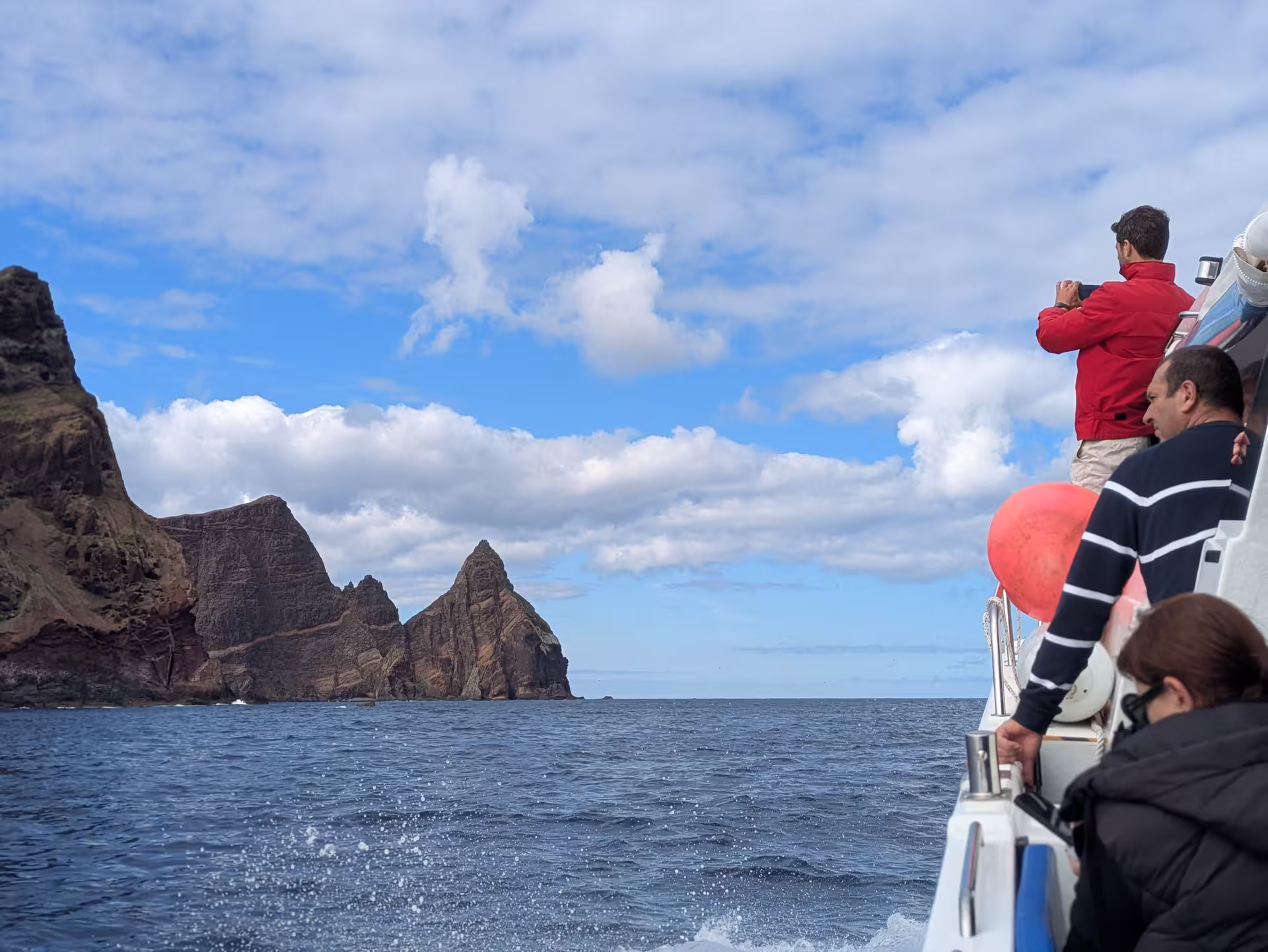 Tourists enjoy breathtaking sea cliffs on a private cruise adventure escape, capturing stunning ocean views.