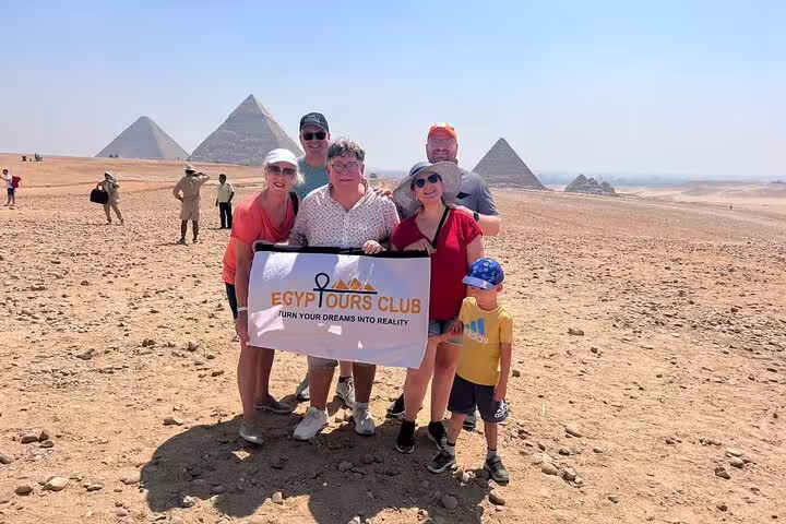 Private day tour group photo at Giza Pyramids desert viewpoint near Cairo, visiting Grand Egyptian Museum