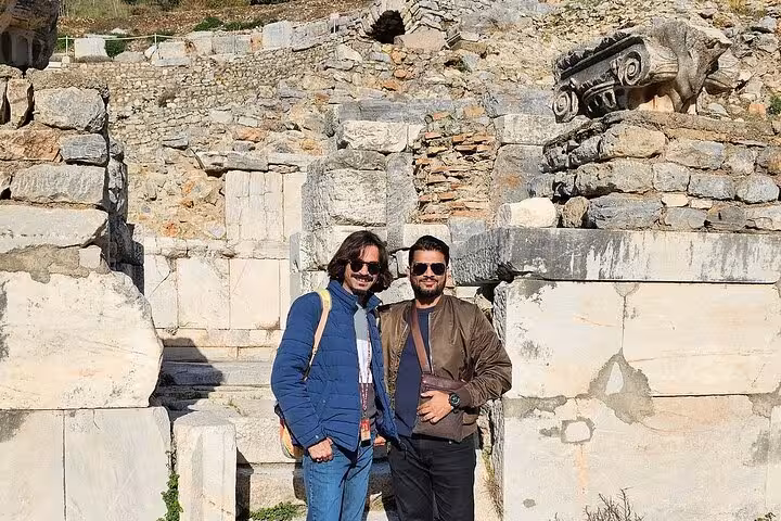 Private Ephesus tour from cruise port with guide and guests posing by ancient marble ruins, skip-the-line experience