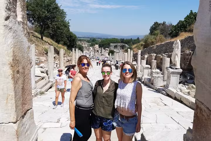 Cruise guests on private Ephesus tour on Curetes Street, walking ancient marble road with ticket included