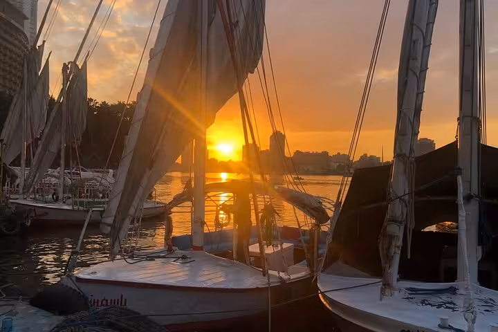 Traditional felucca boats at sunset on the Nile River in Cairo, perfect for a private sailing cruise