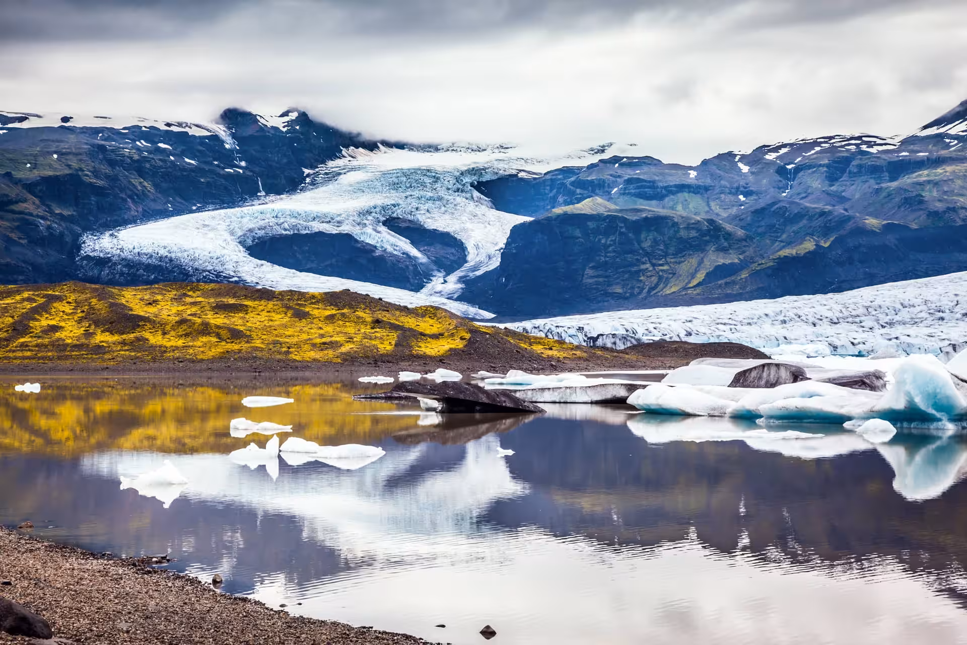 Majestic glacier and vibrant landscape reflecting in the calm waters of the Glacier Lagoon, ideal for a private tour.