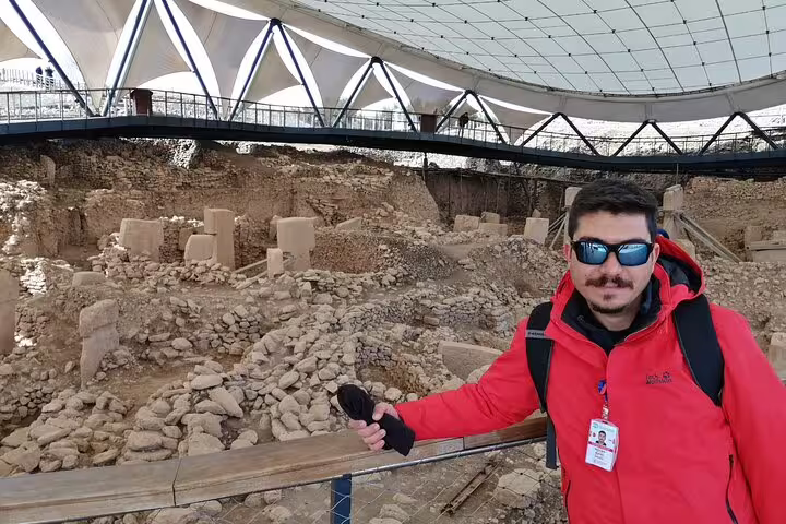 Private Gobeklitepe tour guide at the UNESCO archaeological site in Sanliurfa, Turkey, under canopy