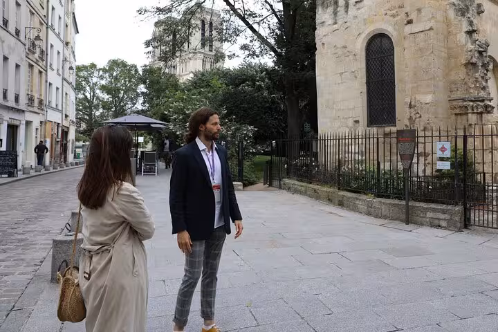 Private guide leads guests near Notre-Dame, exploring medieval Paris streets and cathedral history on foot