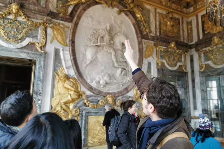Private guide explains ornate Palace of Versailles interior during full-day Giverny and Versailles tour