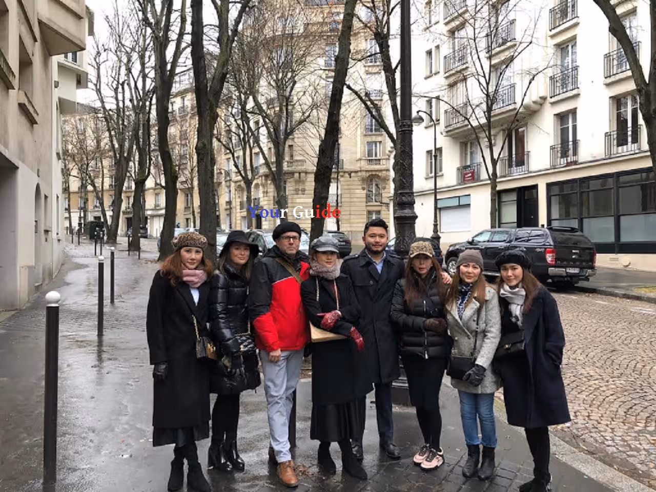 Group of tourists posing on a Parisian street during a private guided tour from Le Havre