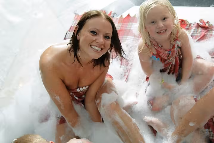 Guests enjoying a private hammam foam bath in Sharm El Sheikh spa, relaxing in bubbles and towels