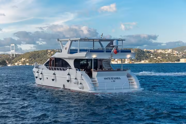 Private Istanbul Bosphorus yacht cruise with luxury motor yacht sailing past the Bosphorus shoreline