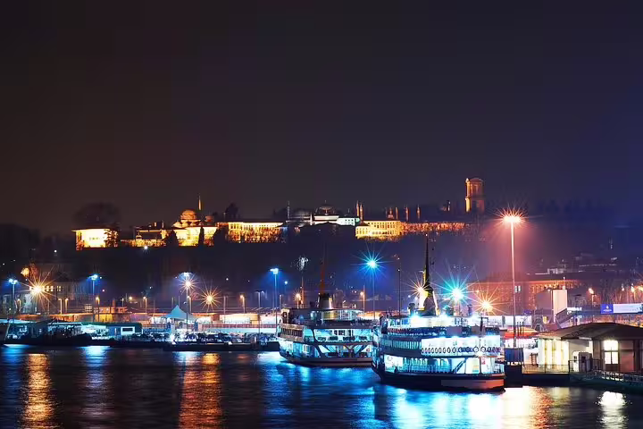Bosphorus waterfront at night with ferries and Old City skyline, private Istanbul night sightseeing experience