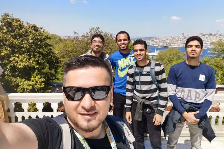 Private Istanbul tour group selfie at a scenic viewpoint overlooking the Bosphorus and city skyline