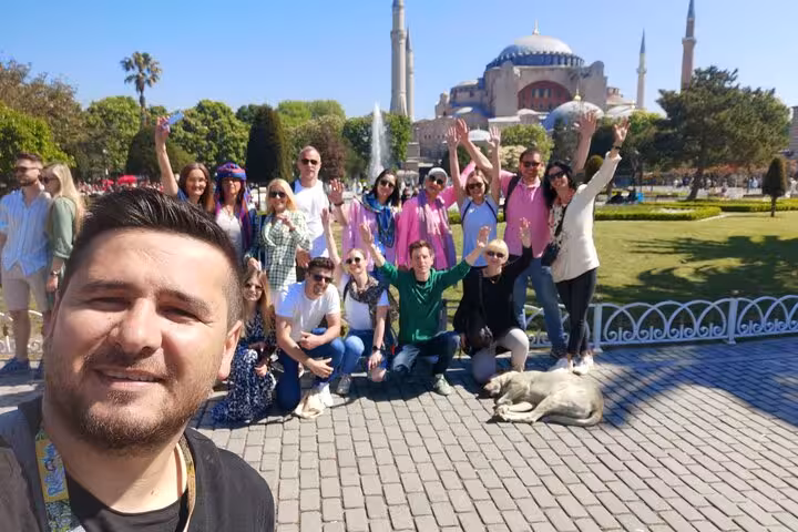 Group on private Istanbul tour posing by Hagia Sophia in Sultanahmet Square on a sunny day