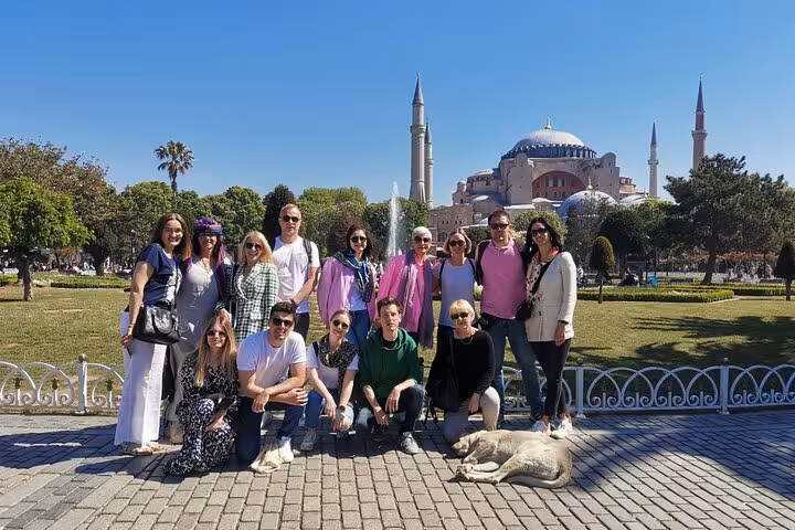 Private Istanbul tour group photo in Sultanahmet Park with Hagia Sophia backdrop and local street cat